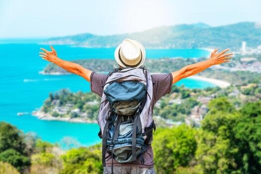 rear-view-portrait-of-young-man-traveler-with-backpack-standing-on-a-mountain-with-arms-spread-open-travel-life-style-and-adventure-concept-free-photo