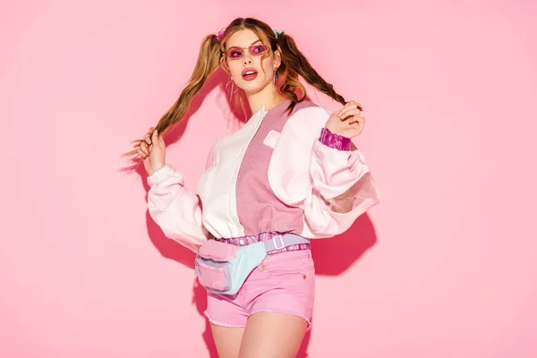 stock-photo-surprised-stylish-girl-sunglasses-waist-bag-touching-hair-pink